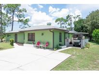 Charming single story home with a carport and well maintained lawn at 29392 Clark Dr, Punta Gorda, FL 33982