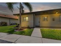 Neat condo exterior with a walkway and landscaping at dusk at 25275 Rampart Blvd # 1801, Punta Gorda, FL 33983