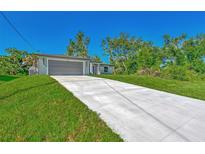 New construction home with gray garage door and concrete driveway at 3847 E Price Blvd, North Port, FL 34288