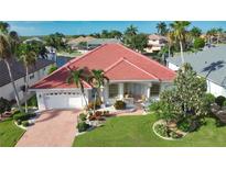 House with red tile roof and landscaped yard at 2259 Ryan Blvd, Punta Gorda, FL 33950