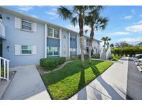 Condo building exterior with walkway and landscaping at 25050 Sandhill Blvd # A4 Bldg 2, Punta Gorda, FL 33983