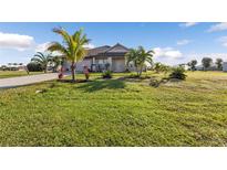 Single-story home with palm trees and a spacious lawn at 17314 Cape Horn Blvd, Punta Gorda, FL 33955
