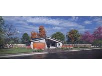 Modern home with a wood garage door and landscaped front yard at 18412 Robinson Ave, Port Charlotte, FL 33948