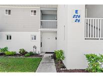 Exterior view of condo building showcasing landscaping and building number at 22375 Edgewater Dr # 126, Port Charlotte, FL 33980