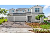 Two-story home exterior with three-car garage and landscaping at 42548 Little Ridge Rd, Punta Gorda, FL 33982