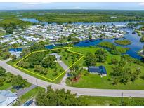 Aerial view of canal front property surrounded by lush vegetation at 8516 Riverside Dr, Punta Gorda, FL 33982