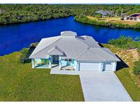 Waterfront home boasting a two-car garage and canal views at 2239 Cornelius Blvd, Port Charlotte, FL 33953