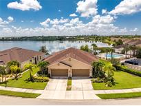 Luxury twin villa with lake view, community pool, and ample parking at 8883 Tuscany Isles Dr, Punta Gorda, FL 33950