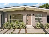 Mid-century modern home with updated exterior and landscaping at 1642 Banyan Dr, Venice, FL 34293