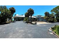 Two-story waterfront home with circular driveway at 1185 Bayshore Dr, Englewood, FL 34223