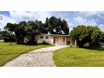 Ranch-style home with a large yard and driveway at 21098 Glendale Ave, Port Charlotte, FL 33952