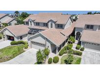 Beautiful two-story home with a tile roof, attached garage, landscaped yard, and screened-in patio at 3800 Bal Harbor Blvd # 212, Punta Gorda, FL 33950