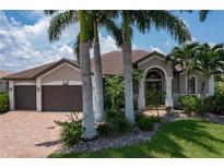 Single-Gathering home with a two-car garage and palm trees at 3439 Nighthawk Ct, Punta Gorda, FL 33950