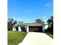 Single-story home with a modern exterior and driveway at 17046 Smith Ave, Port Charlotte, FL 33954