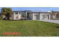 A modern two-story home with a metal roof and large garage at 24051 Pyramid Way, Punta Gorda, FL 33955