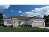 One-story home with beige exterior, two-car garage, and landscaped lawn at 378 Lawler St, Port Charlotte, FL 33954