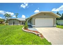 Single-Gathering home with two-car garage and landscaped yard at 20222 Banner Ave, Port Charlotte, FL 33952