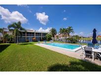 Community pool with lounge chairs and patio furniture at 3251 White Ibis Ct # C4, Punta Gorda, FL 33950