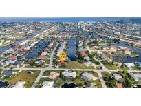 Bird's-eye view of waterfront home in a canal community at 1520 Appian Dr, Punta Gorda, FL 33950