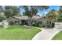 One-story house with landscaping and driveway at 182 Monica St, Port Charlotte, FL 33954