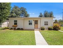Cozy one-story home with a light-colored facade and well-maintained lawn at 3372 Lucerne Ter, Port Charlotte, FL 33952
