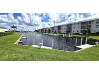 Community dock with boats and lush green landscaping at 3600 Bal Harbor Blvd # 1-O, Punta Gorda, FL 33950