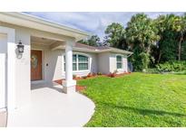 Charming single-Gathering home with a well-manicured lawn and inviting front porch at 3159 Draper Ter, North Port, FL 34286