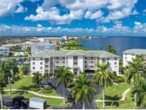 Waterfront condo building with lush landscaping at 1250 W Marion Ave # 242, Punta Gorda, FL 33950
