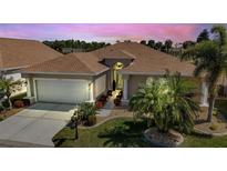 One-story home with tile roof and landscaped front yard at 24588 Buckingham Way, Port Charlotte, FL 33980