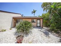 Charming single-story home featuring desert landscaping and a neutral exterior paint scheme on a sunny day at 1001 W Marion Ave # 14, Punta Gorda, FL 33950