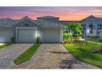 Two-car garage and attractive landscaping in front of this beautiful home at 14194 Heritage Landing Blvd # 624, Punta Gorda, FL 33955