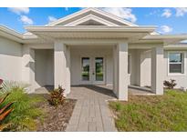 Inviting exterior with covered entryway and walkway at 9461 Attica Cir, Port Charlotte, FL 33981