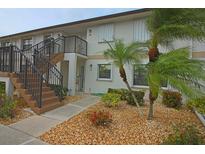 Condo building with a stairway and landscaping at 26485 Rampart Blvd # D6, Punta Gorda, FL 33983