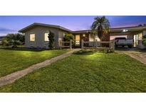 House exterior at dusk with a well-maintained lawn at 22557 Bolanos Ct, Port Charlotte, FL 33952