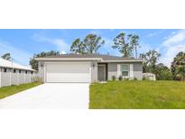 Single Gathering home with a well-manicured lawn at 860 Phyllis St, Port Charlotte, FL 33948