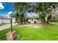 Charming single-story house with a well-maintained front yard at 335 Kenova St, Port Charlotte, FL 33954