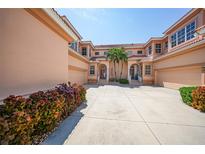 Three-story building with attached garages and lush landscaping at 3959 San Rocco Ct # 911, Punta Gorda, FL 33950