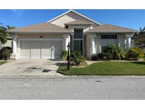 One-story house with a two-car garage and lush landscaping at 24059 Buckingham Way, Punta Gorda, FL 33980