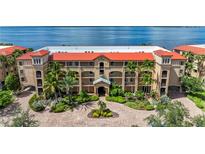Aerial view of Mediterranean style building, lush landscaping at 89 Vivante Blvd # 305, Punta Gorda, FL 33950