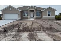 Charming single Gathering home with a two car garage, neutral colored stucco, and a well manicured lawn at 8347 Ada St, Port Charlotte, FL 33981