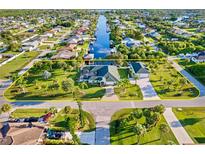 Aerial view of single Gathering home on a canal lot at 18605 Ackerman Ave, Port Charlotte, FL 33948