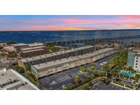 Aerial view of waterfront condo building with parking and nearby bridge at 150 Harborside Ave # 216, Punta Gorda, FL 33950