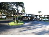 Exterior view of condo building with covered parking at 255 Mission S Trl # J, Venice, FL 34285