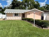 Ranch-style home with a carport and well-maintained lawn at 829 Pineland Ave, Venice, FL 34285