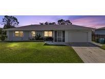 One-story home with attached garage and well-manicured lawn at 17341 Sabrina Cir, Port Charlotte, FL 33948