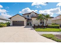 Beautiful two-story stucco home with tile roof, lush landscaping and a spacious driveway and two-car garage at 5241 Grand Palmetto Way, North Port, FL 34291
