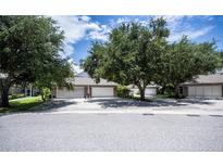Exterior view of three-car garage and driveway at 1274 White Oak Trl, Port Charlotte, FL 33948