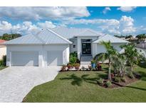 Modern, single-story home with metal roof and landscaped yard at 1735 Boca Raton Ct, Punta Gorda, FL 33950