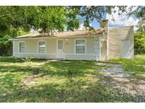 Cute single story home with a well-manicured lawn and mature trees at 2624 Lee St, Punta Gorda, FL 33950