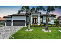 Luxury home with two-car garage and manicured lawn at 4006 San Massimo Dr, Punta Gorda, FL 33950